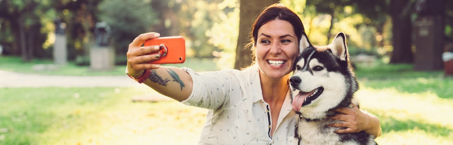 Woman taking a selfie with a husky