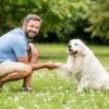 Man shaking the paw of a dog