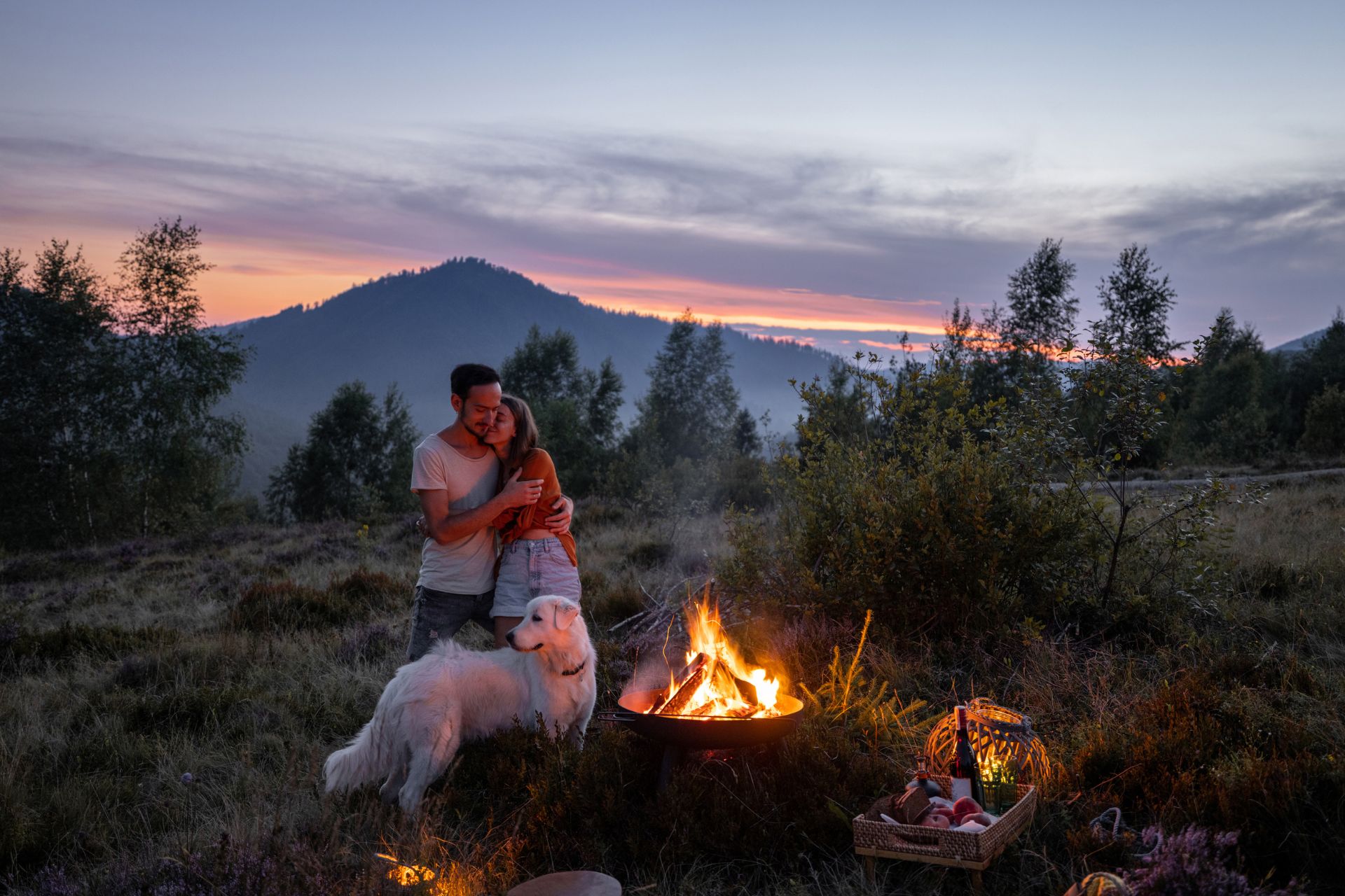 A couple Camping with a Dog