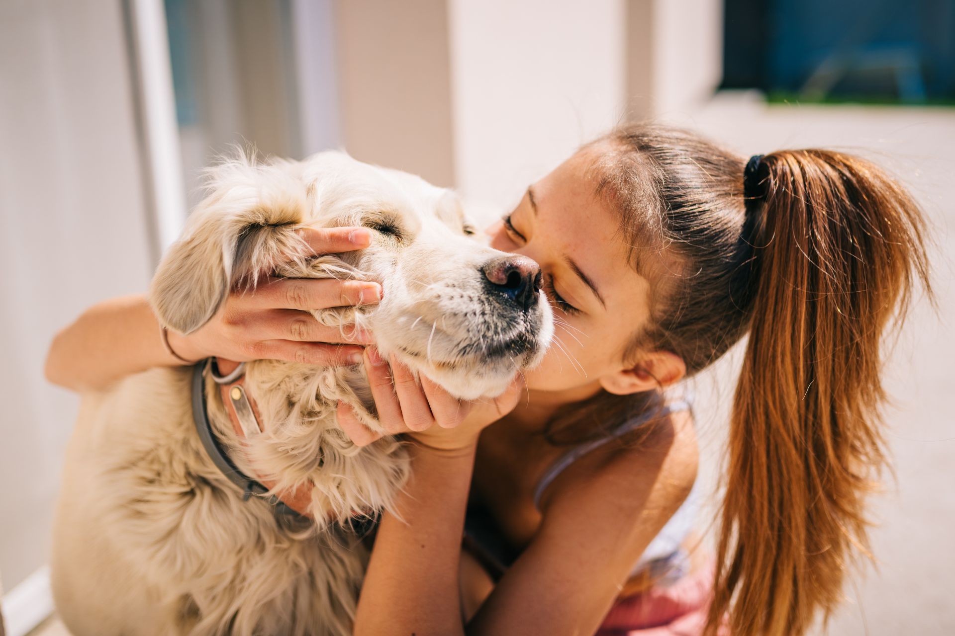 A girl kissing a dog