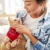 Woman holding a cat with a bandana