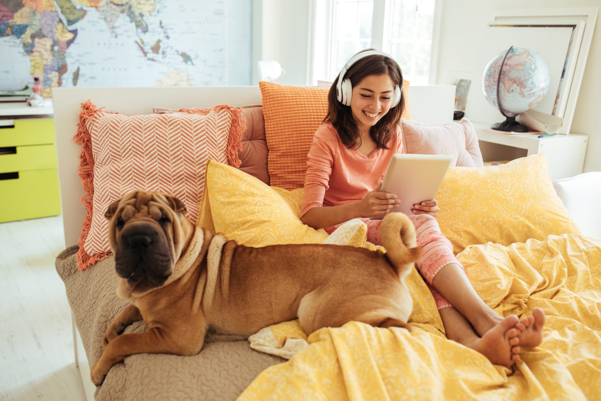 Woman on her bed with a dog next to her